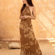 Elegant halter neck maxi dress with floral and bird print, perfect for boho beach style