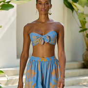 Blue floral strapless top with front bow and matching wide-leg pants, styled for confident, graceful summer wear