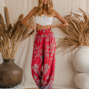 Red floral print wide-leg pants with white crop top, boho chic style