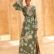 Elegant green floral maxi dress with bell sleeves and side slit, perfect for boho chic style